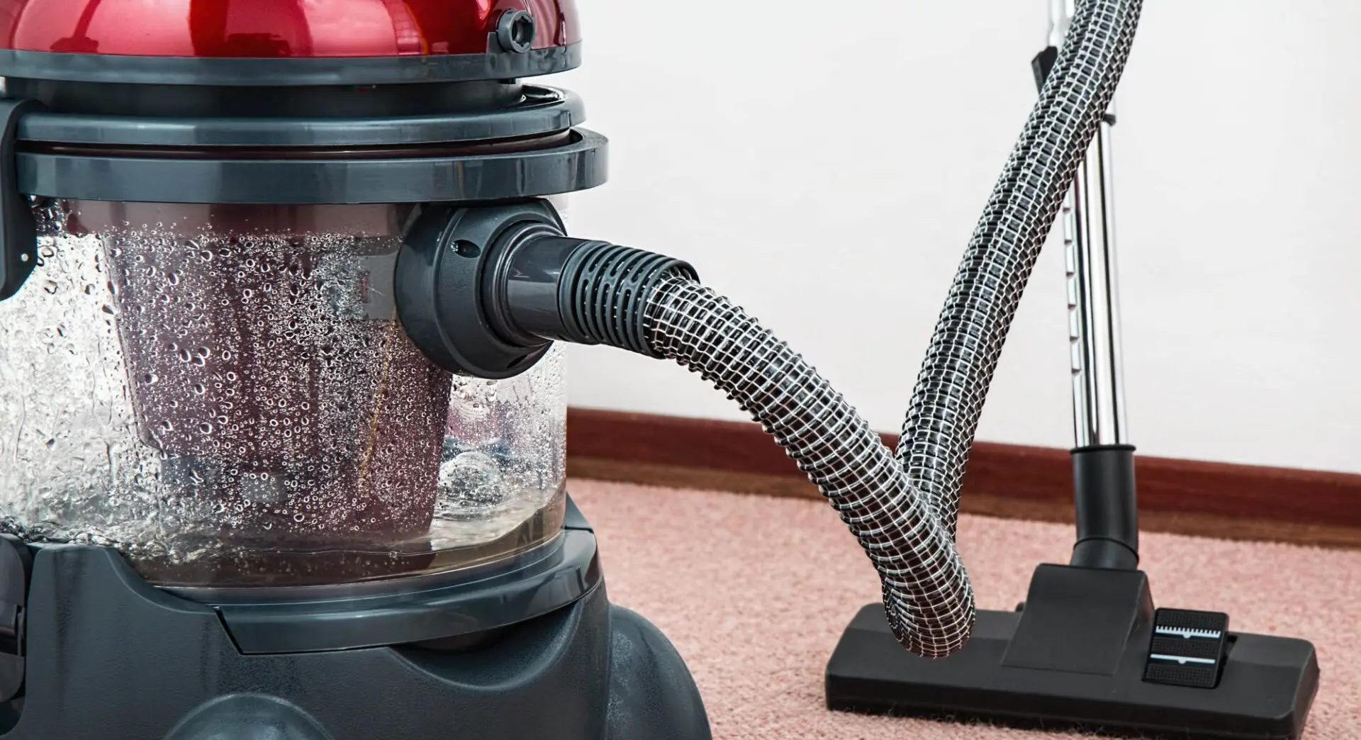 A vacuum cleaner in a room with water on it.