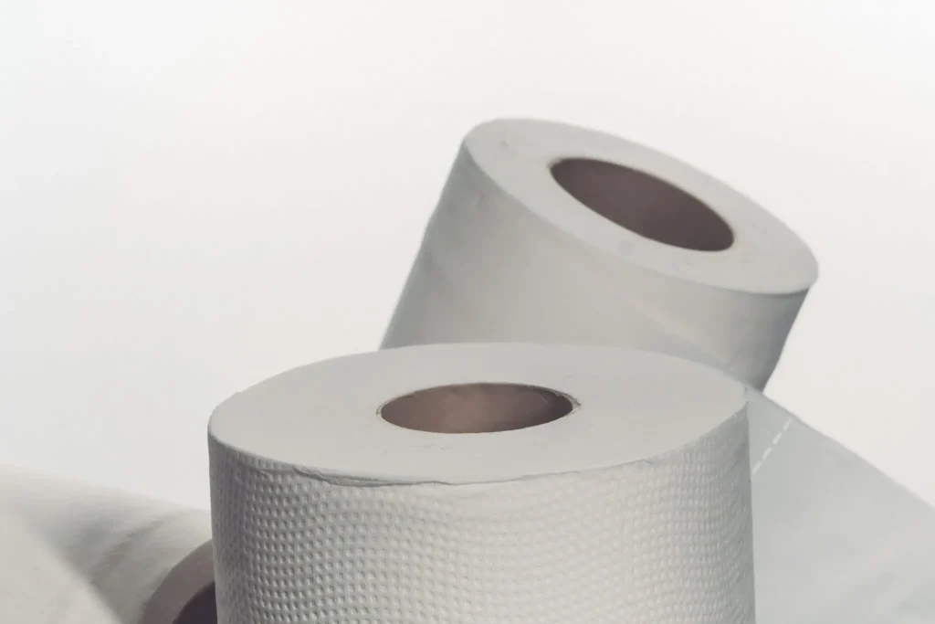 Three rolls of white toilet paper on a white background.