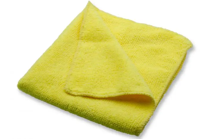 A yellow microfiber towel on a white background.